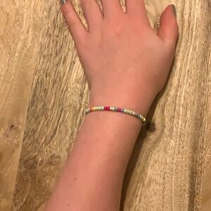 it is a kids bracelet about 5 inches long and multicolored
